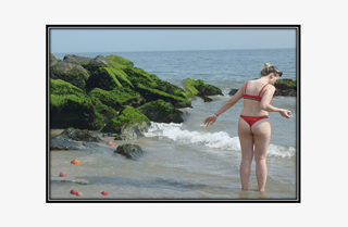 girl in thong swimsuit collecting seashells