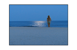 moon reflection on water by beach with girl