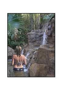 woman walking in rock waterfall